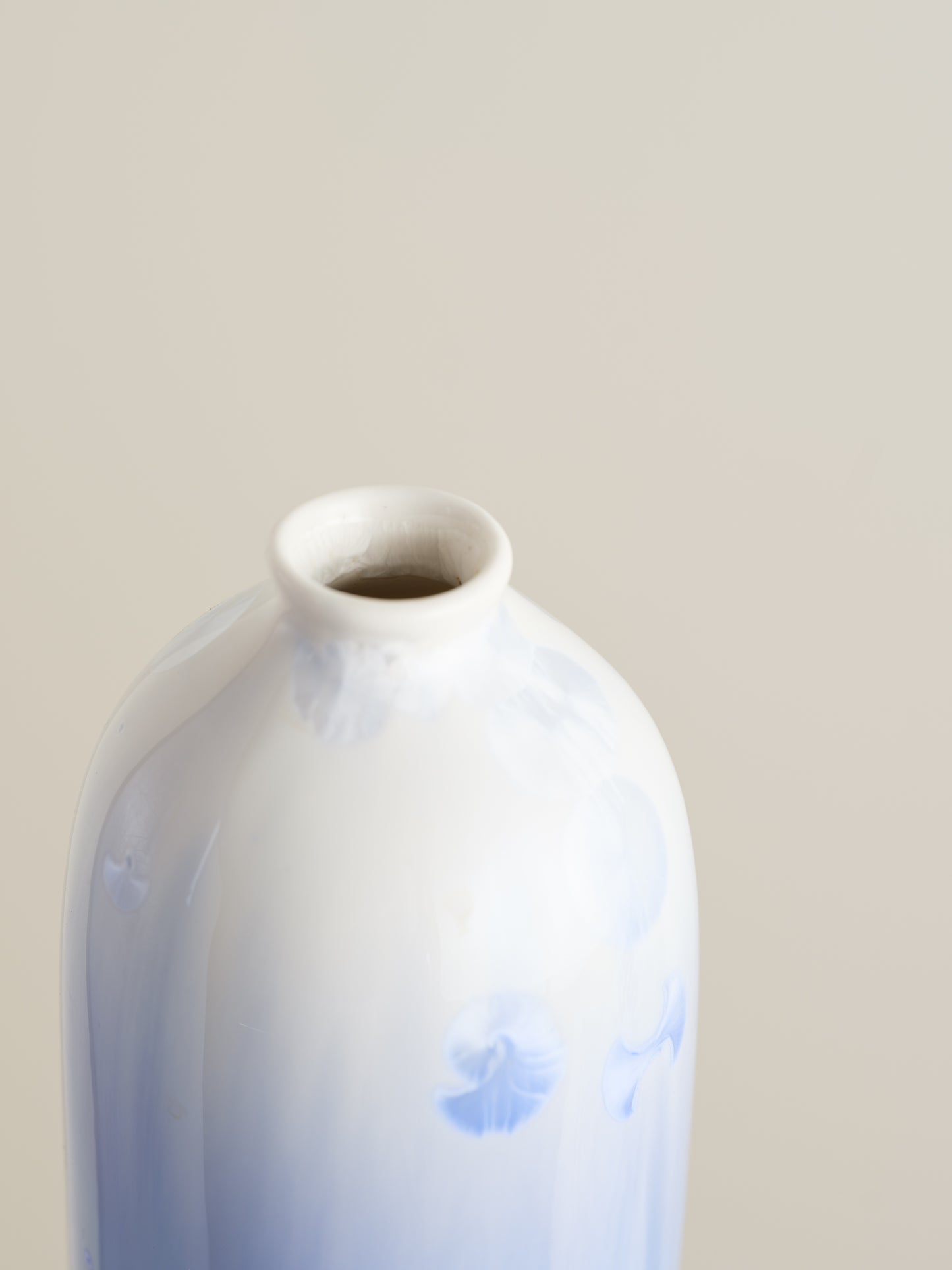 Tall crystalline glaze vase in gradient indigo blue with circular crystal bloom resembling a moon motif.