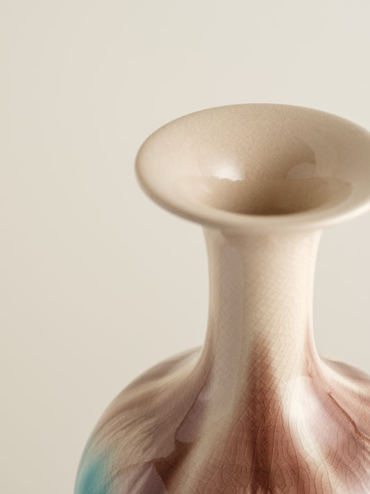 Ceramic vase with turquoise and beige drip glaze, featuring a flared neck and rounded form.