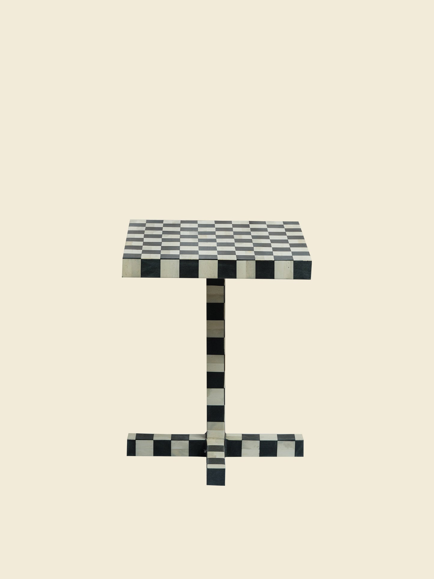 Modern black and white checkerboard side table with square top and pedestal base