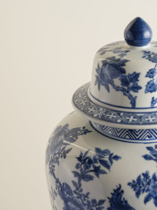 Blue and white porcelain ginger jar with phoenix and floral motif.