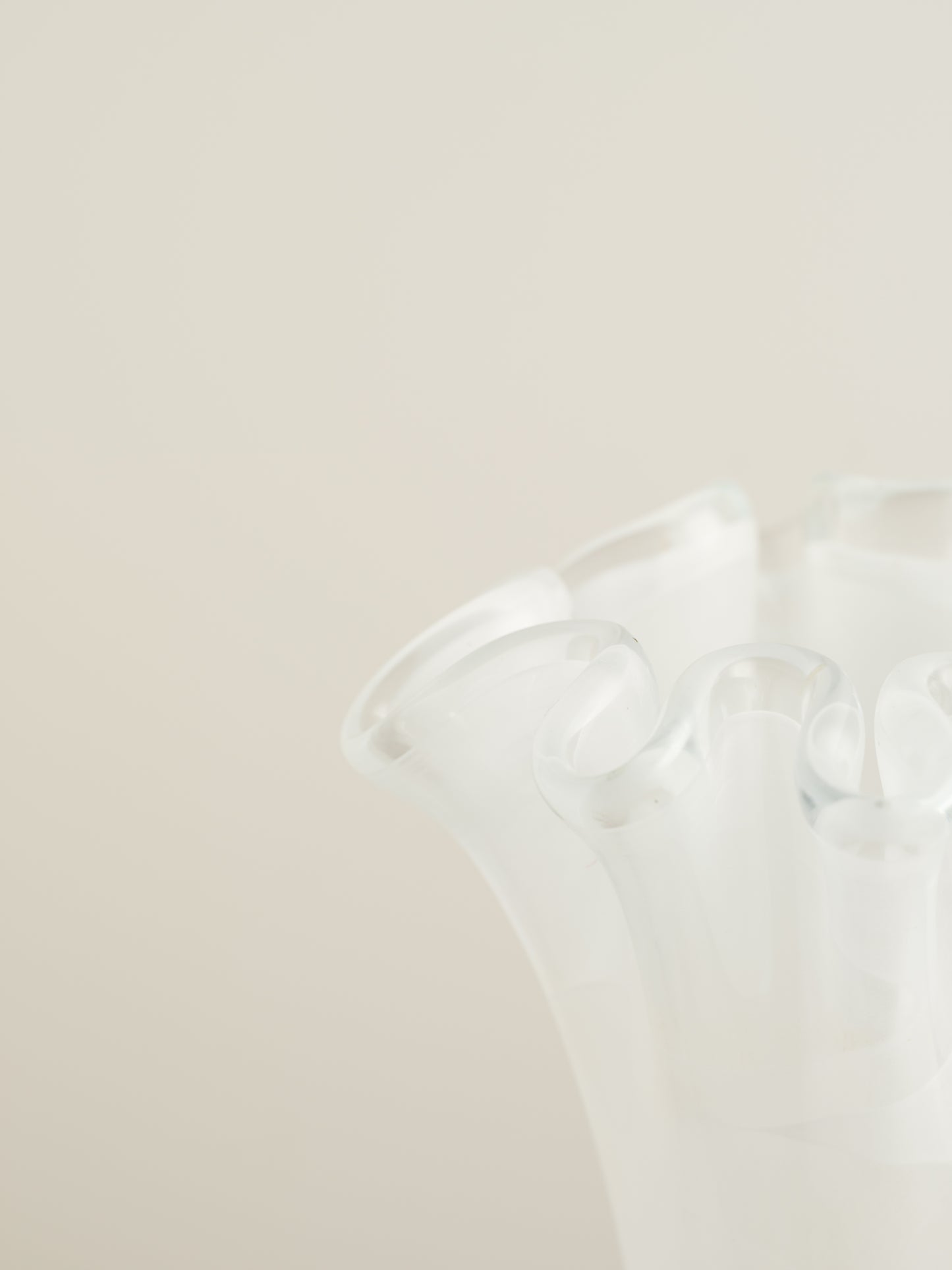White opaline glass vase with softly ruffled petal rim and cloud-like translucence.