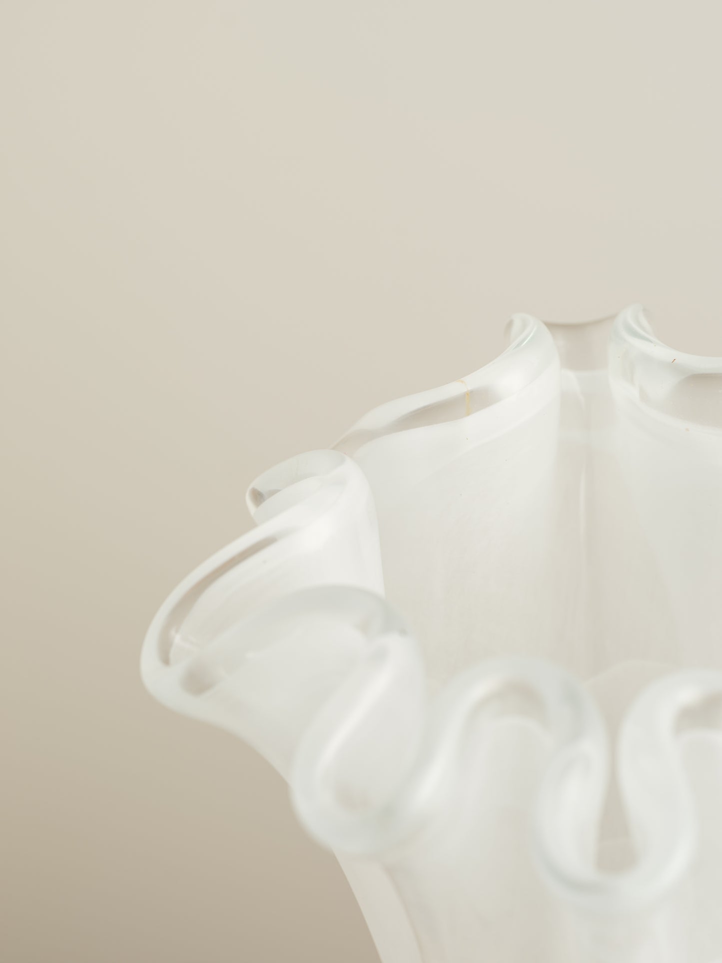 White opaline glass vase with softly ruffled petal rim and cloud-like translucence.