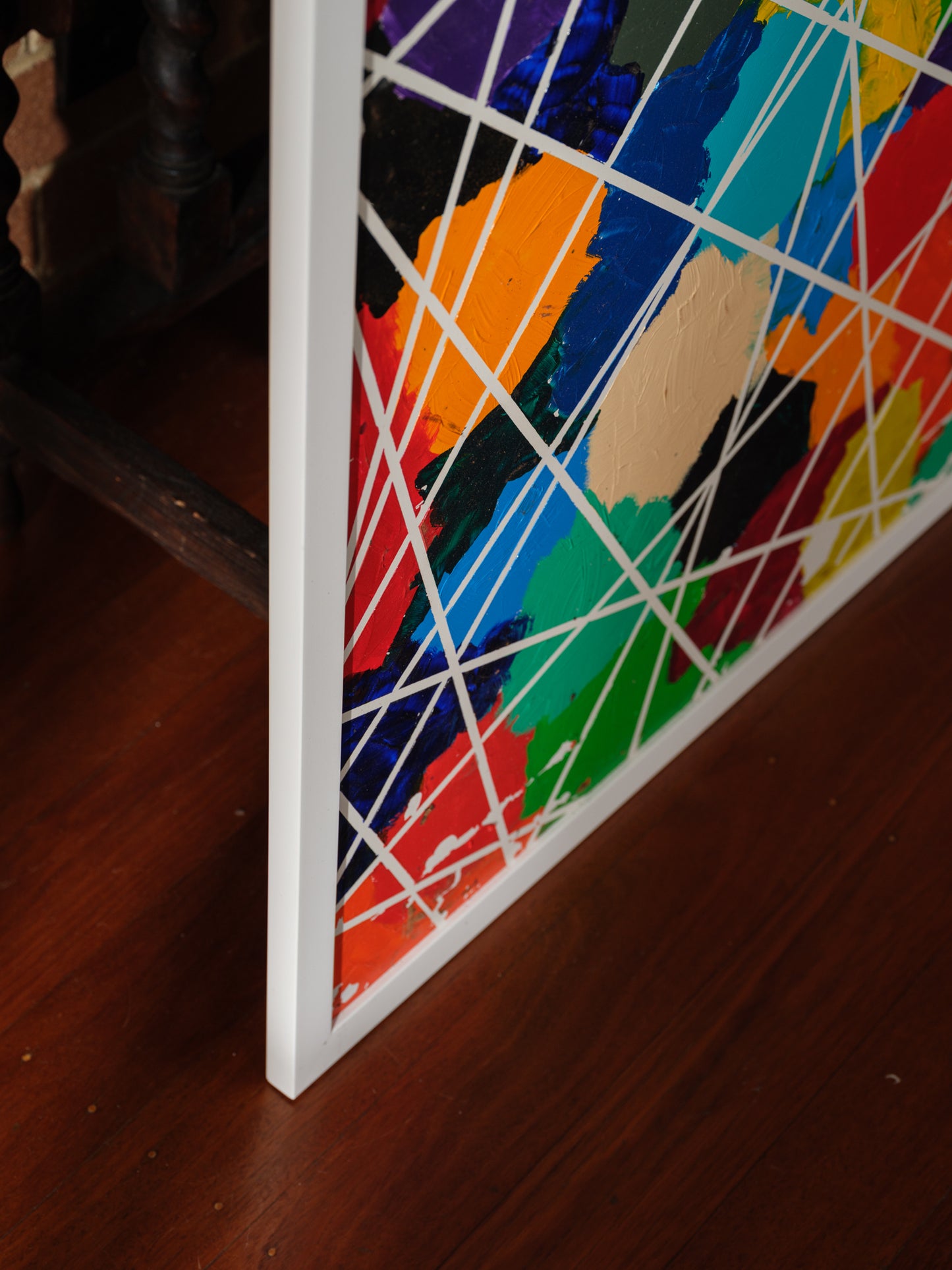 Abstract acrylic painting titled Constellations of Color, featuring vibrant patches of bold hues intersected with geometric white lines.