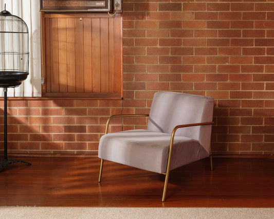 Contemporary lounge accent chair with soft grey upholstery and gold metal frame