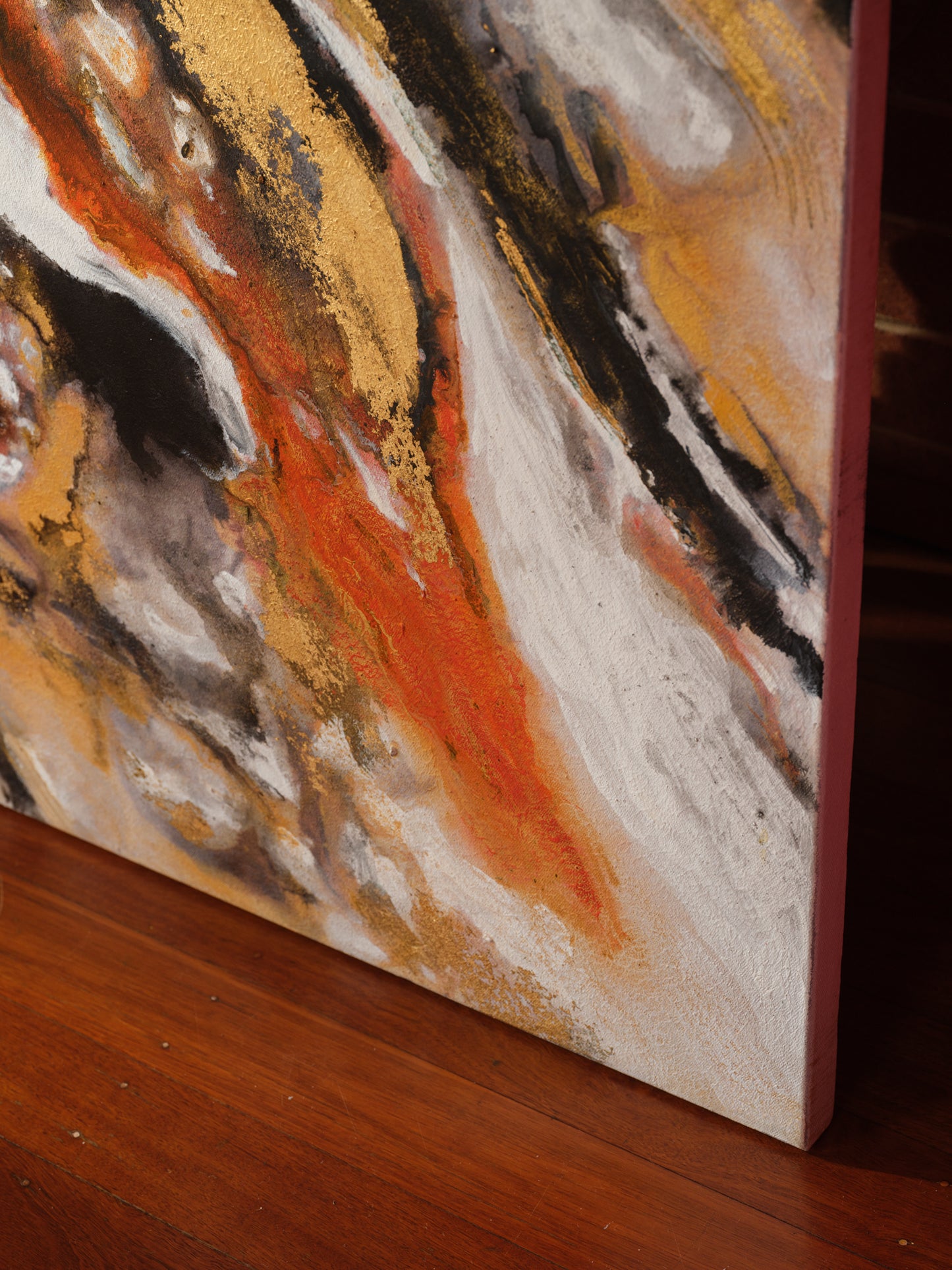 Abstract acrylic painting titled Ember Current, featuring dynamic swirls of gold, black, white, and fiery orange tones.