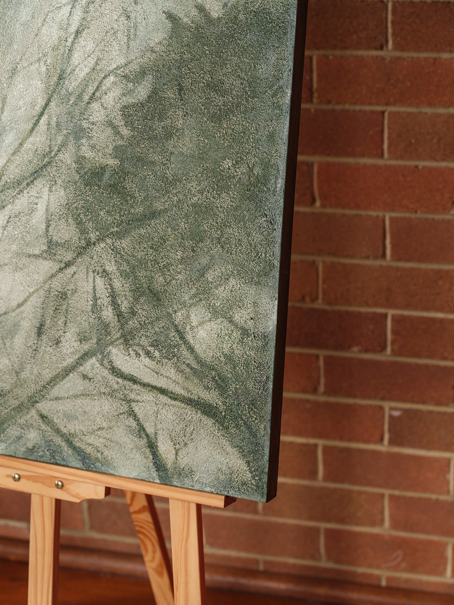 Abstract painting titled Forest Veil, featuring layered green brushstrokes resembling foliage on canvas.