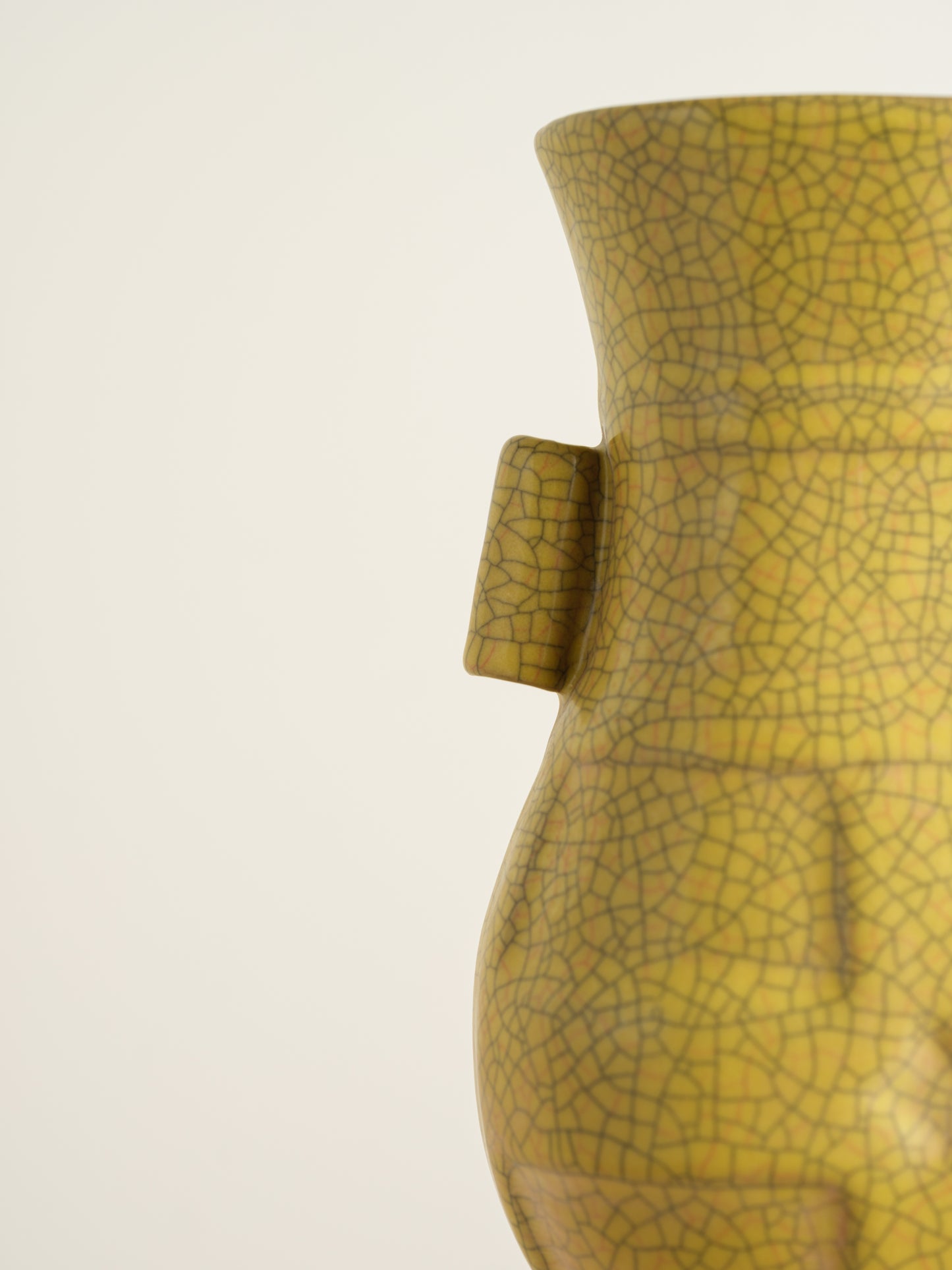 Golden Lattice Celadon Vase, featuring a yellow crackle glaze with geometric patterns and twin side handles.