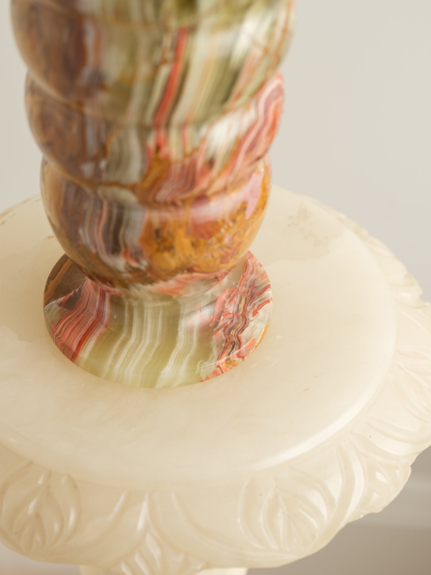 Honey Onyx Ripple Vase with natural striations in warm amber, cream, and green tones, carved in a rippled cylindrical form.