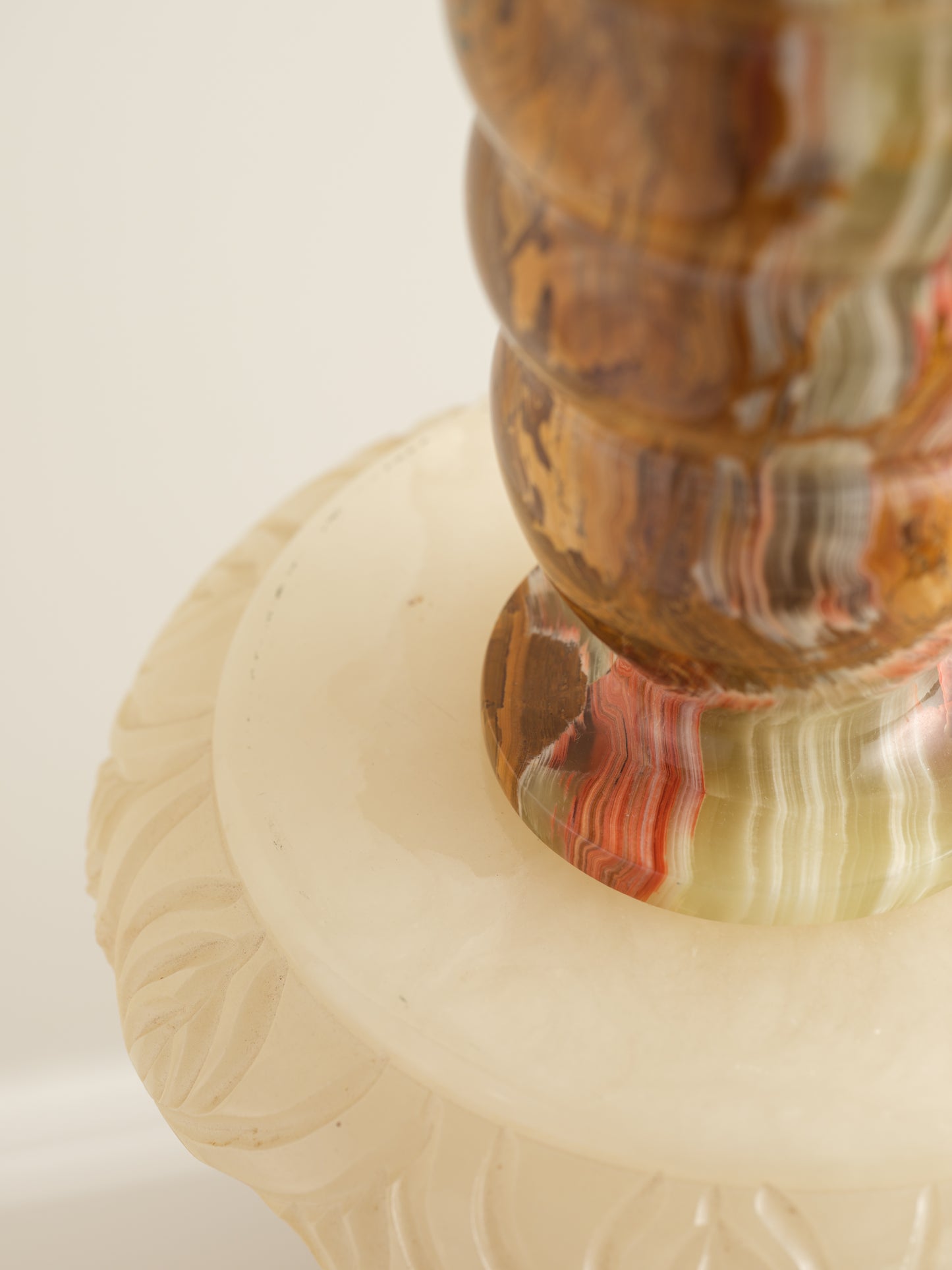 Honey Onyx Ripple Vase with natural striations in warm amber, cream, and green tones, carved in a rippled cylindrical form.