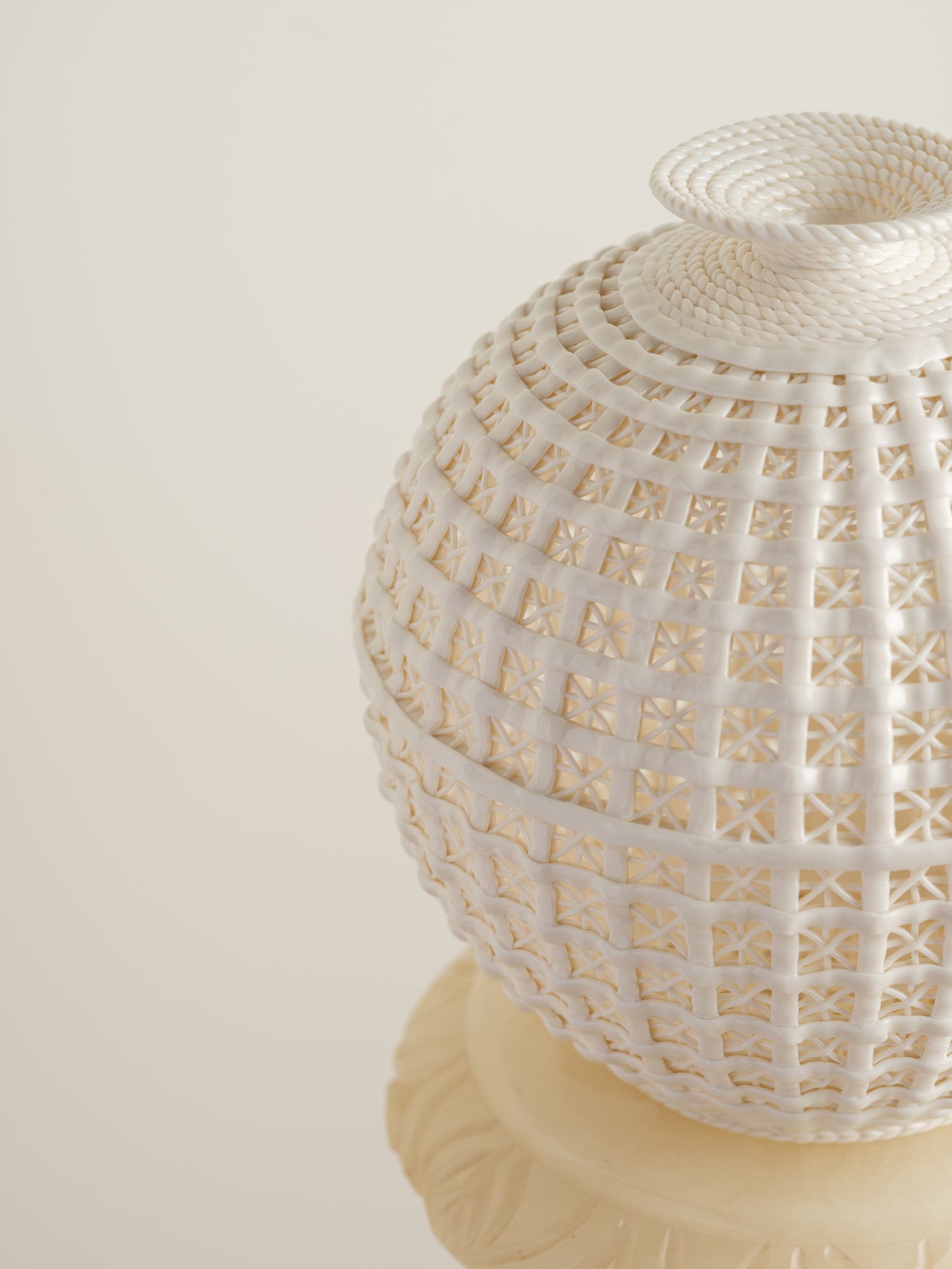 White porcelain meiping vase with openwork lattice pattern and flared rim.
