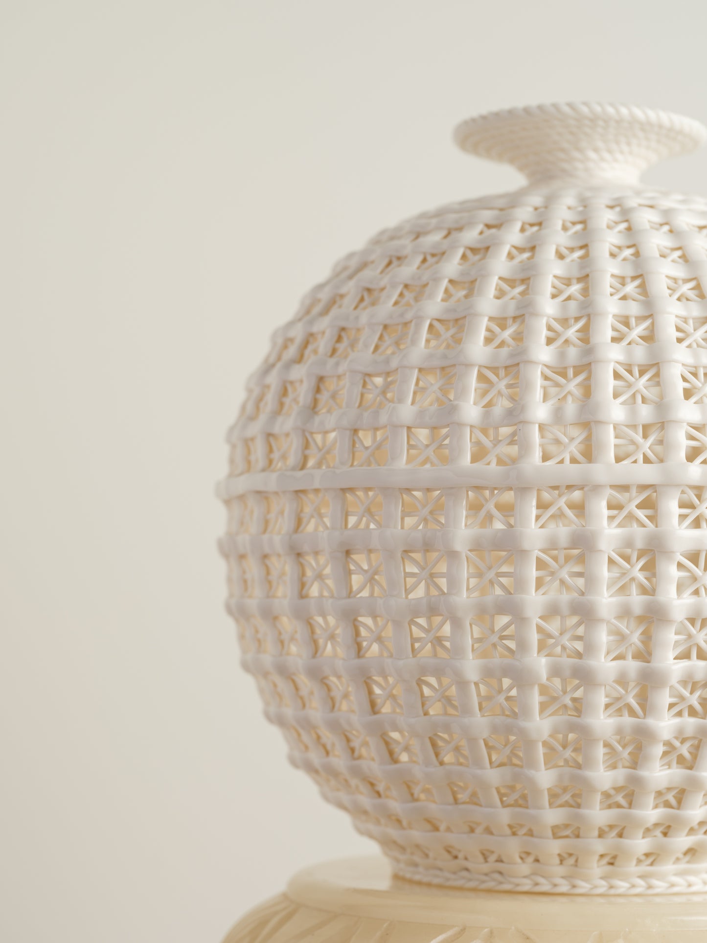 White porcelain meiping vase with openwork lattice pattern and flared rim.