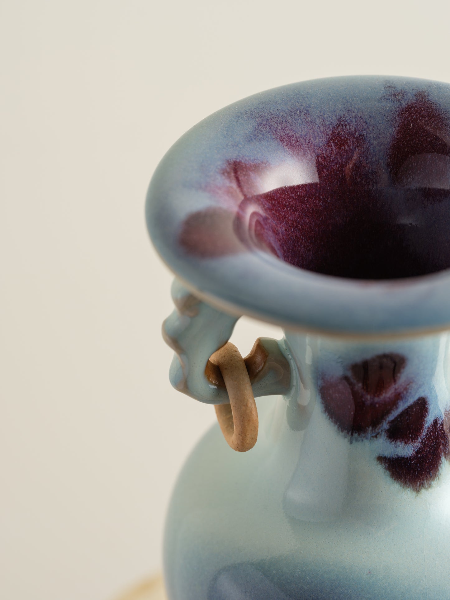 Small Jun-style vase with blue and purple glaze and twin ring handles.
