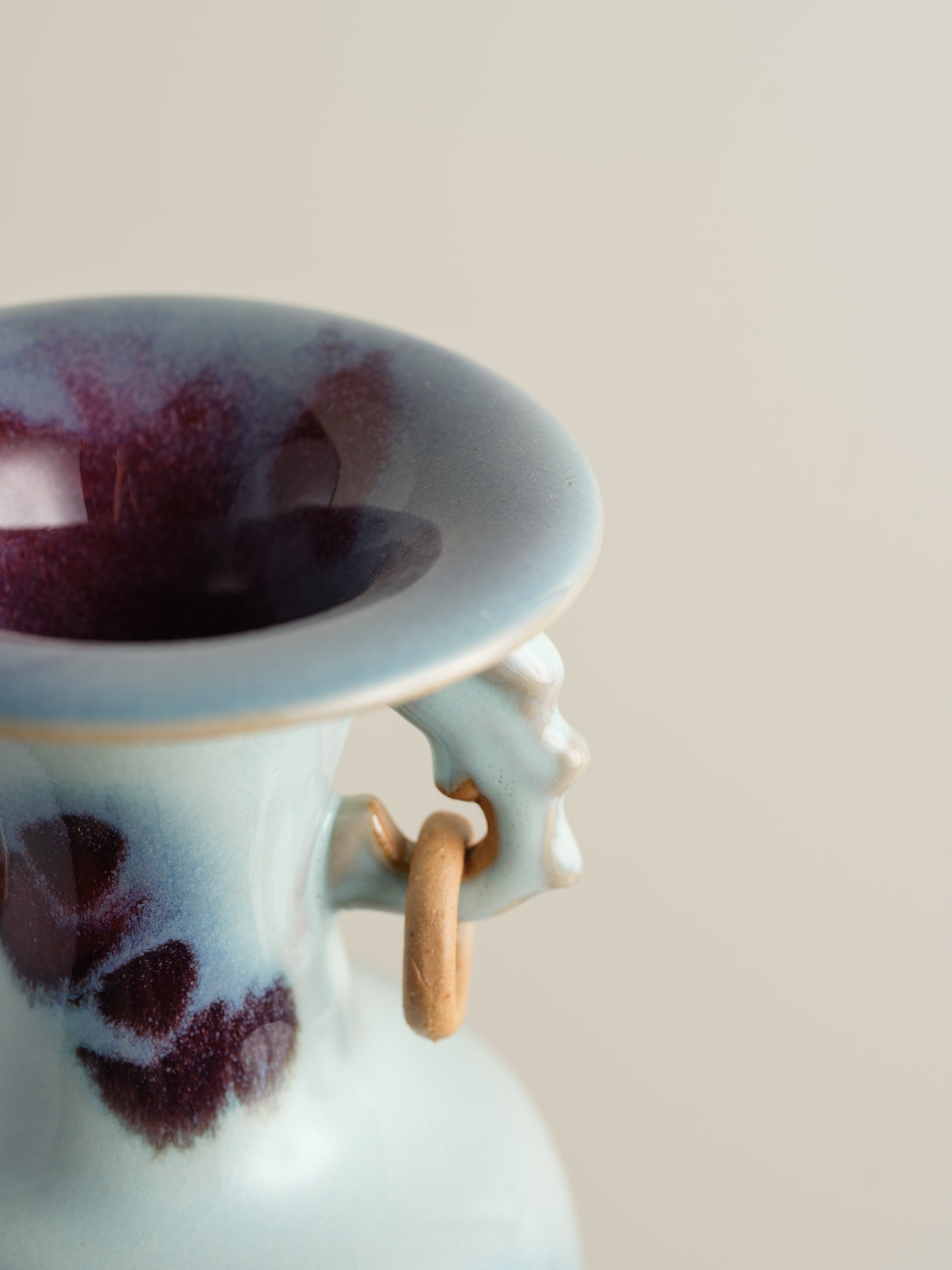 Small Jun-style vase with blue and purple glaze and twin ring handles.