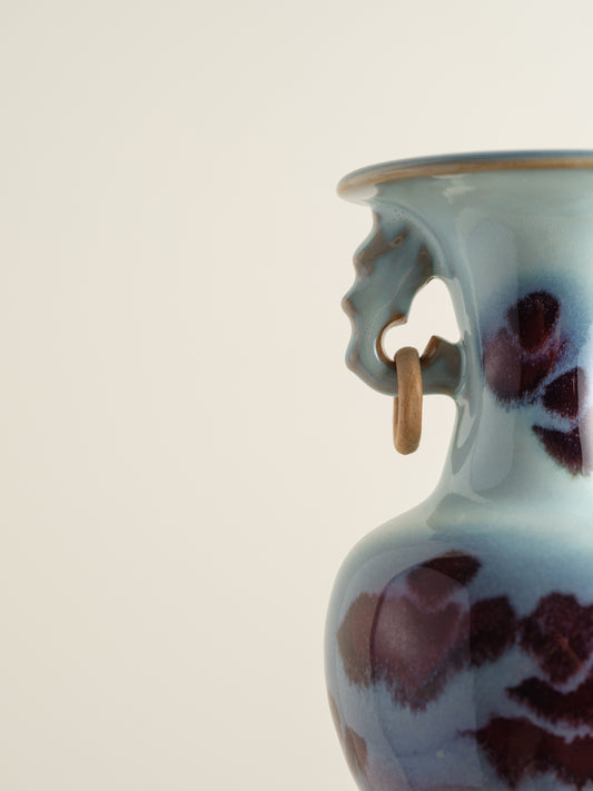 Small Jun-style vase with blue and purple glaze and twin ring handles.