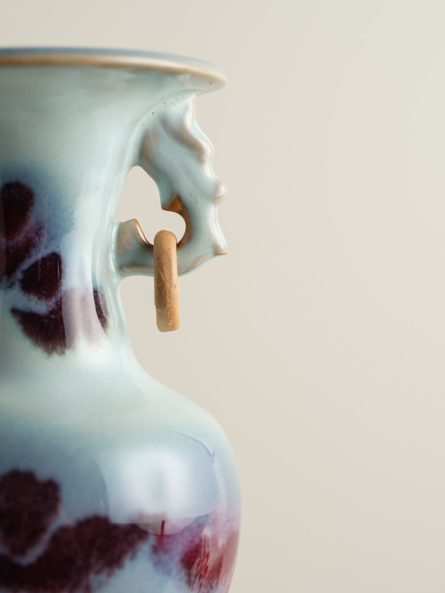 Small Jun-style vase with blue and purple glaze and twin ring handles.