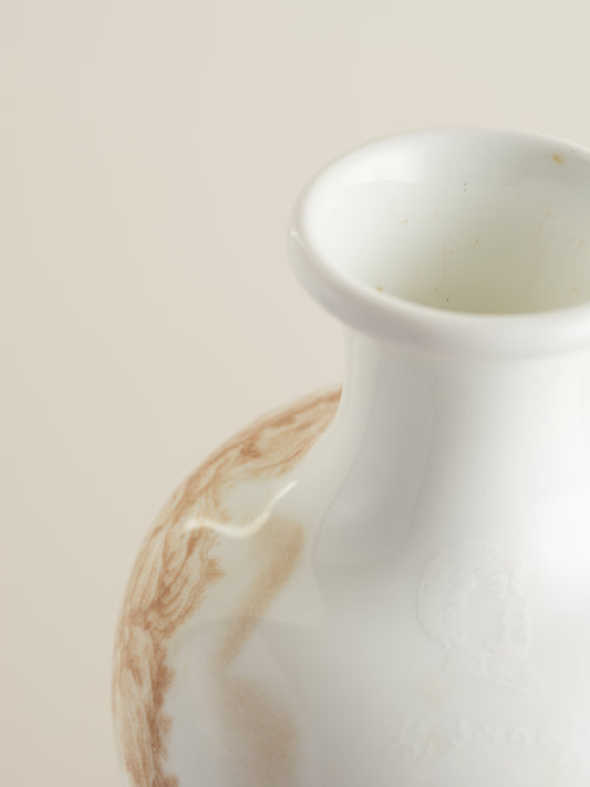 Porcelain vase with tea-wash glaze and hand-painted sepia landscape scene of mountains and flying birds.