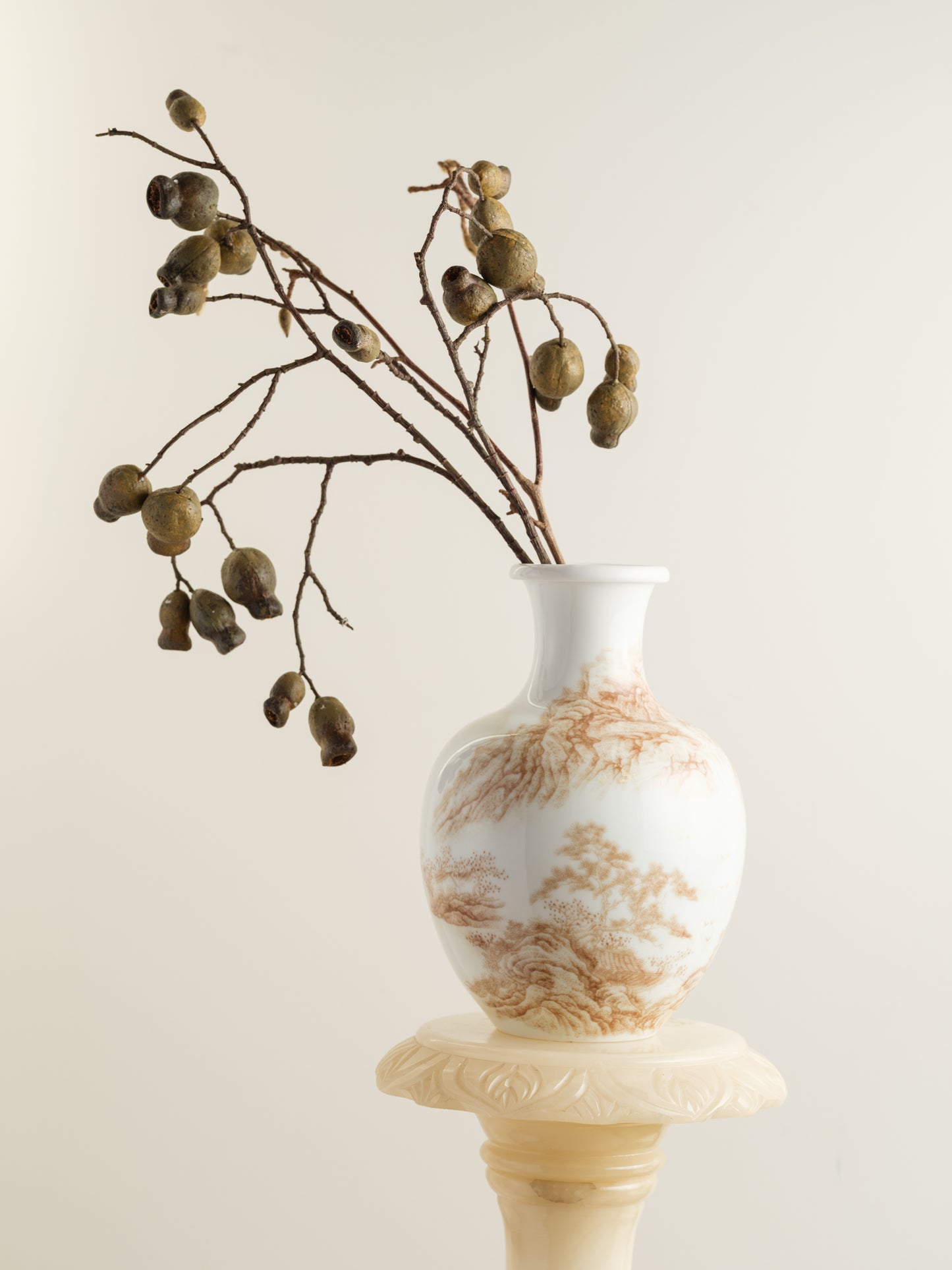 Porcelain vase with tea-wash glaze and hand-painted sepia landscape scene of mountains and flying birds.