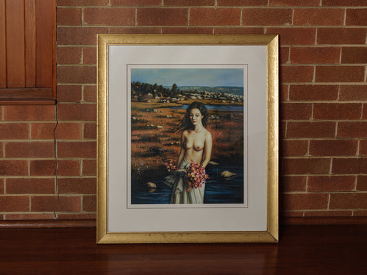 Framed artwork titled “Maiden of the Meadow” featuring a woman holding flowers in a meadow landscape, with gold frame and white mat.