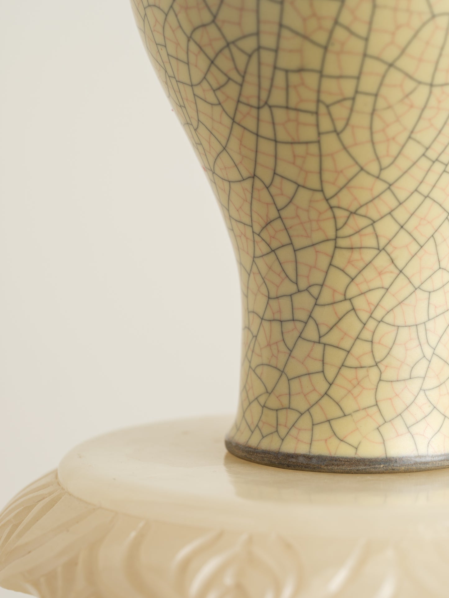 Celadon Crackle Meiping Vase, a traditional ceramic vessel with elegant curves and fine crackle glaze pattern, displayed on a pedestal.