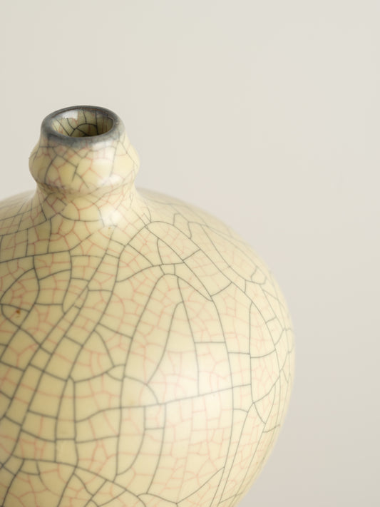 Celadon Crackle Meiping Vase, a traditional ceramic vessel with elegant curves and fine crackle glaze pattern, displayed on a pedestal.