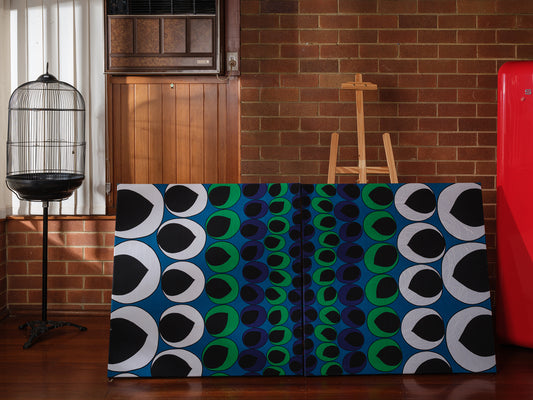 Peacock Rhythm Diptych, a set of two textile artworks with bold circular patterns in blue, green, black, and white, mounted on stretcher frames.