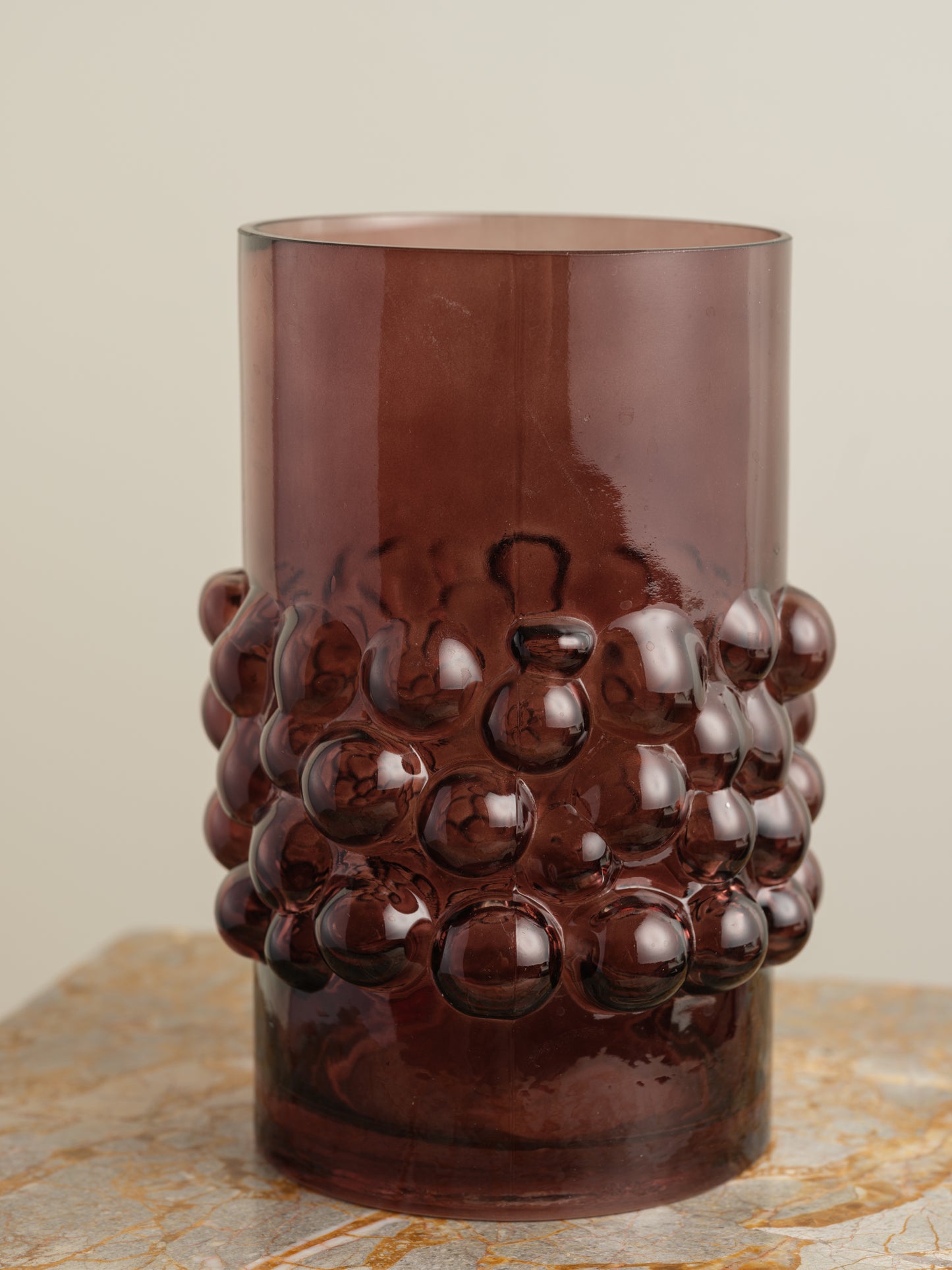 Deep plum-coloured glass vase with cylindrical form and raised hobnail texture around the middle.