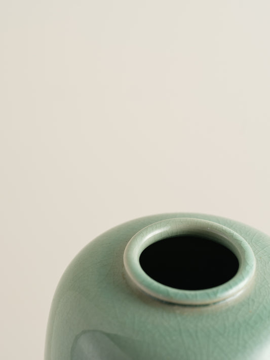 Petite celadon jar with fine crackle glaze, hand-painted plum blossoms and a sparrow motif.