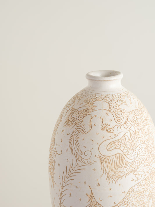Sgraffito ceramic vase titled Qilin Whisper, featuring an ivory surface etched with a mythological qilin design in soft beige tones.