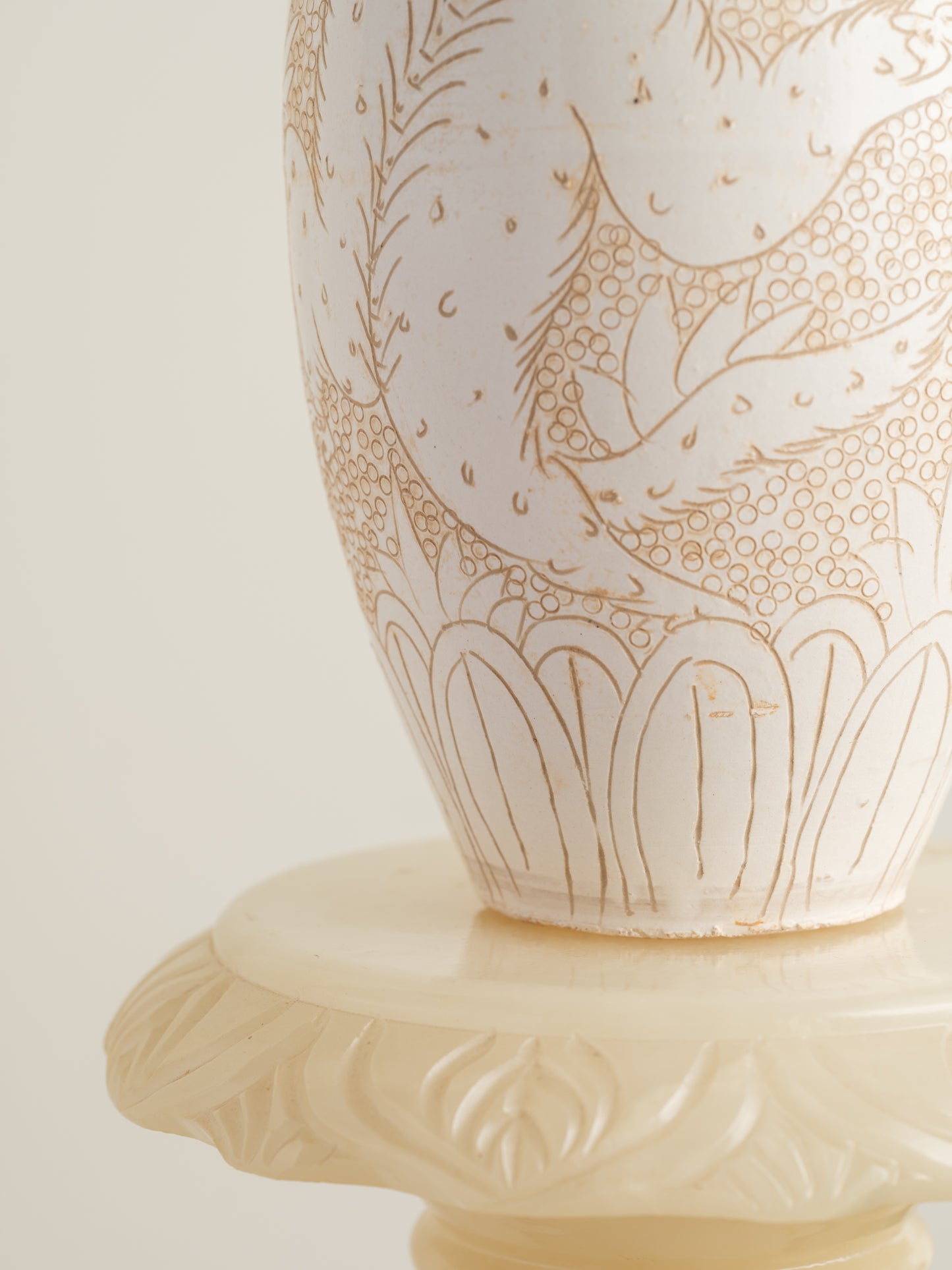 Sgraffito ceramic vase titled Qilin Whisper, featuring an ivory surface etched with a mythological qilin design in soft beige tones.
