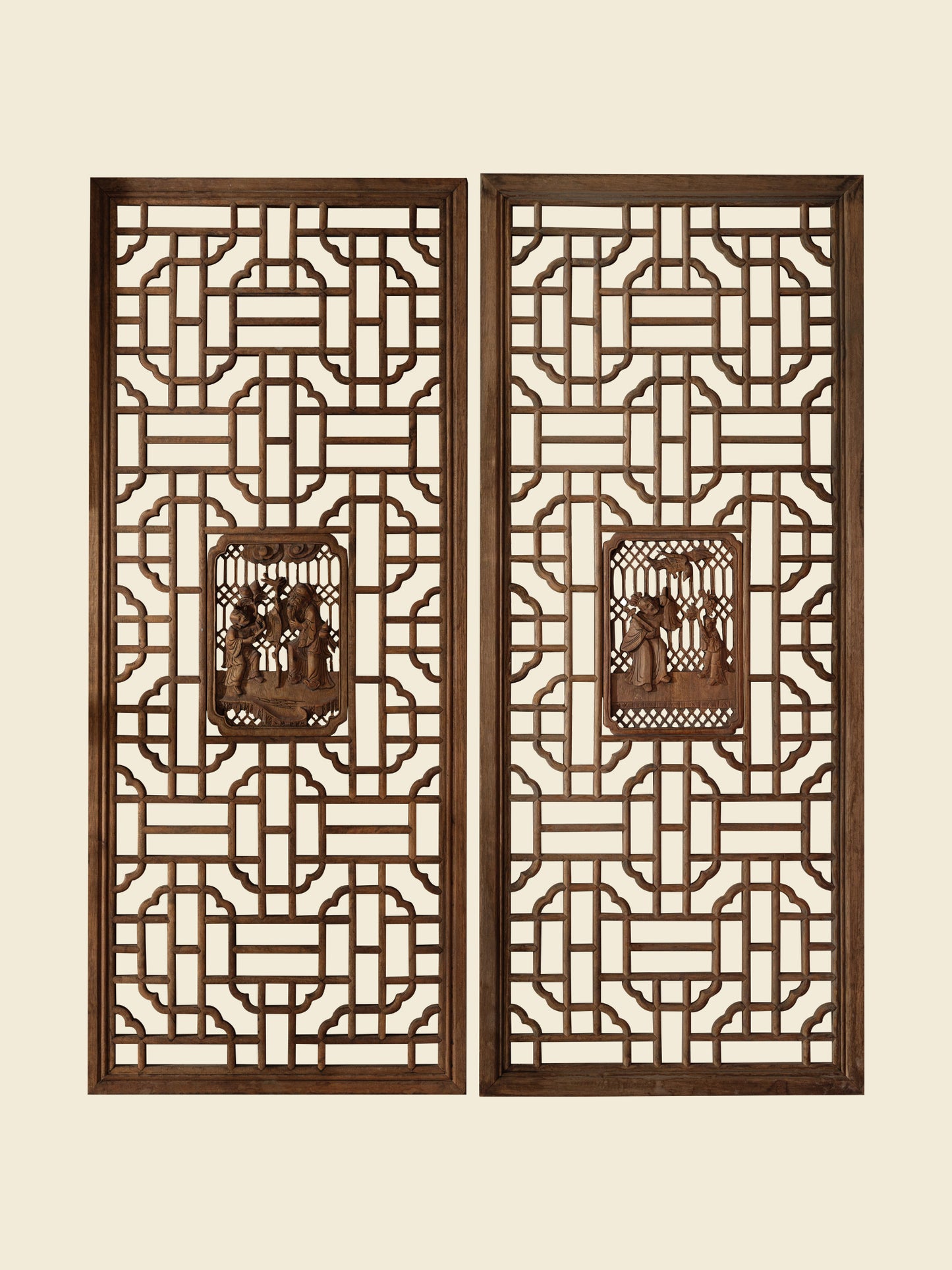 Pair of antique Chinese lattice panels with intricate geometric fretwork and carved scholar scenes in relief at the center.