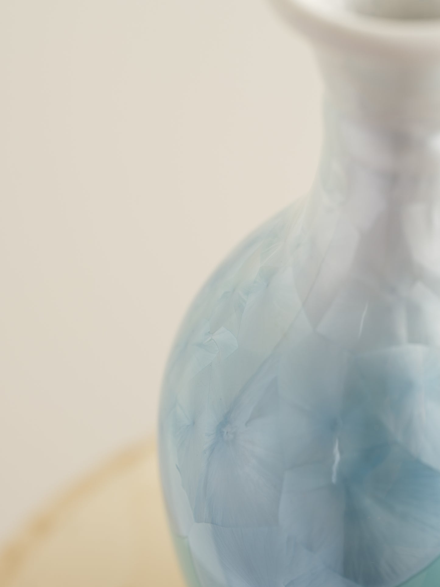 Porcelain vase in gradient white to aqua blue with crystalline bloom patterns on the surface.