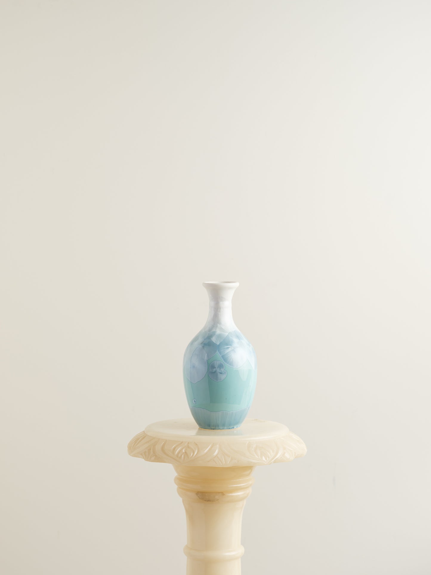 Porcelain vase in gradient white to aqua blue with crystalline bloom patterns on the surface.