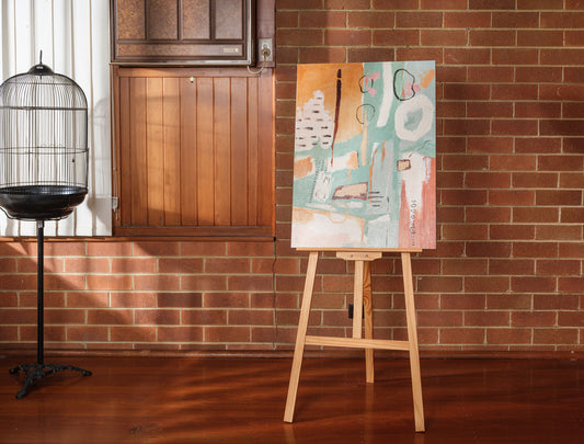 Abstract painting titled Soft Geometry at Dusk, featuring pastel orange, teal, and blush geometric shapes with expressive brushstrokes on canvas.