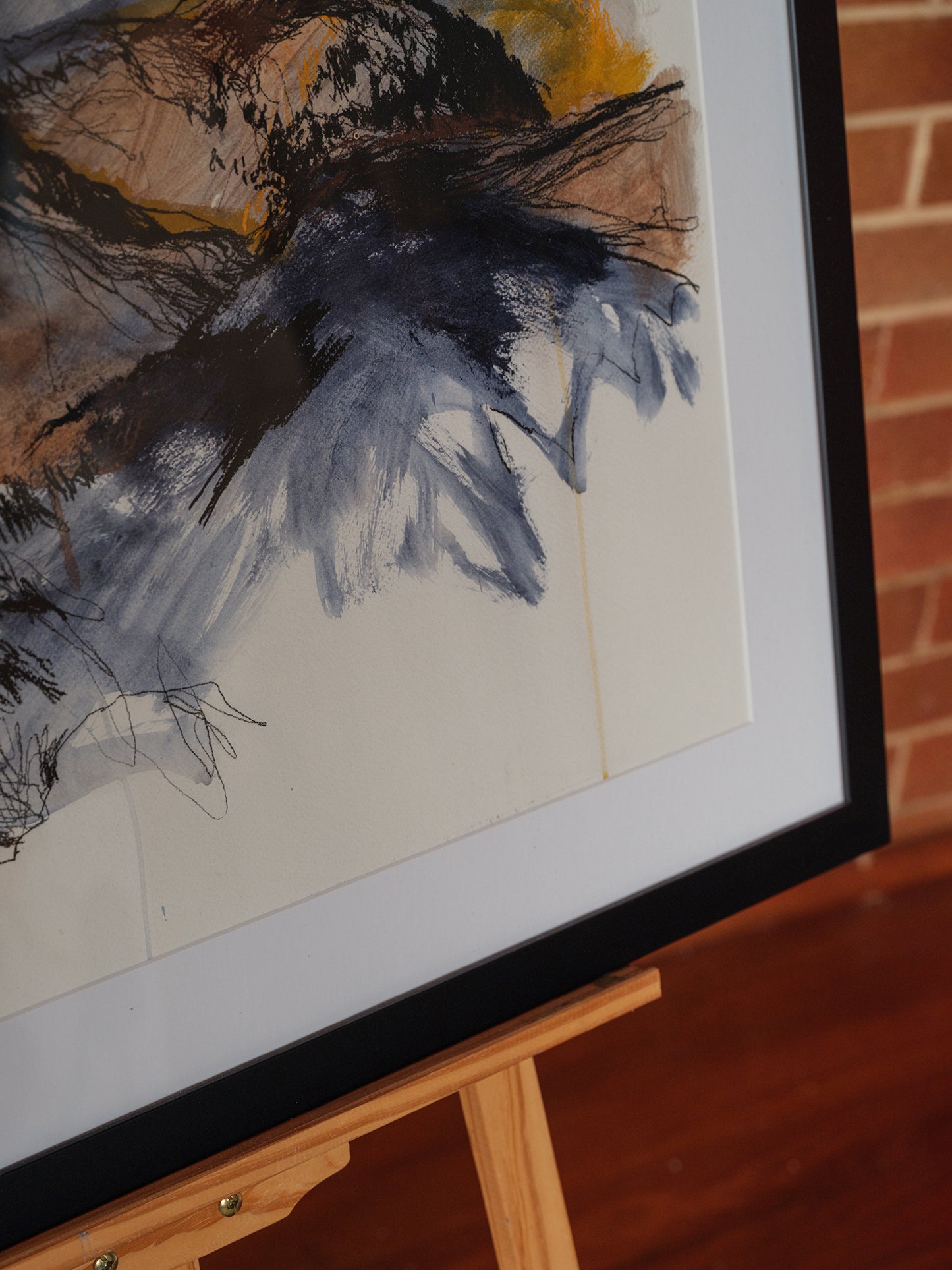 Framed drawing titled Storm Over Ridges (2021) by Melanie Cooper, created with acrylic and charcoal on paper, signed and presented under glass