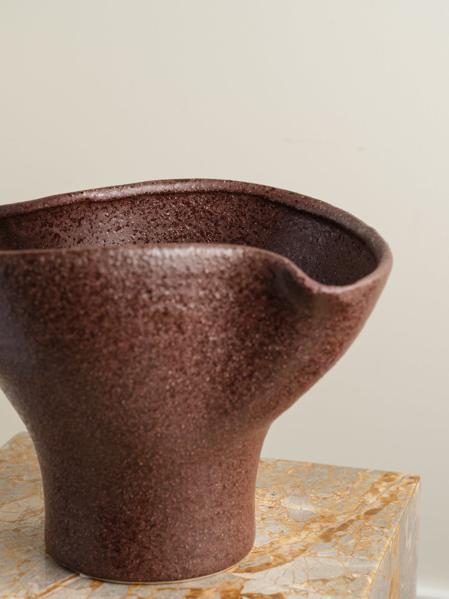 Hand-thrown brown stoneware vase with textured matte glaze and flared crest rim.