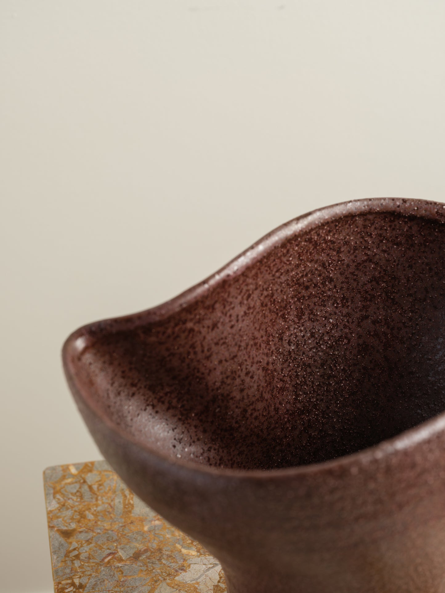 Hand-thrown brown stoneware vase with textured matte glaze and flared crest rim.