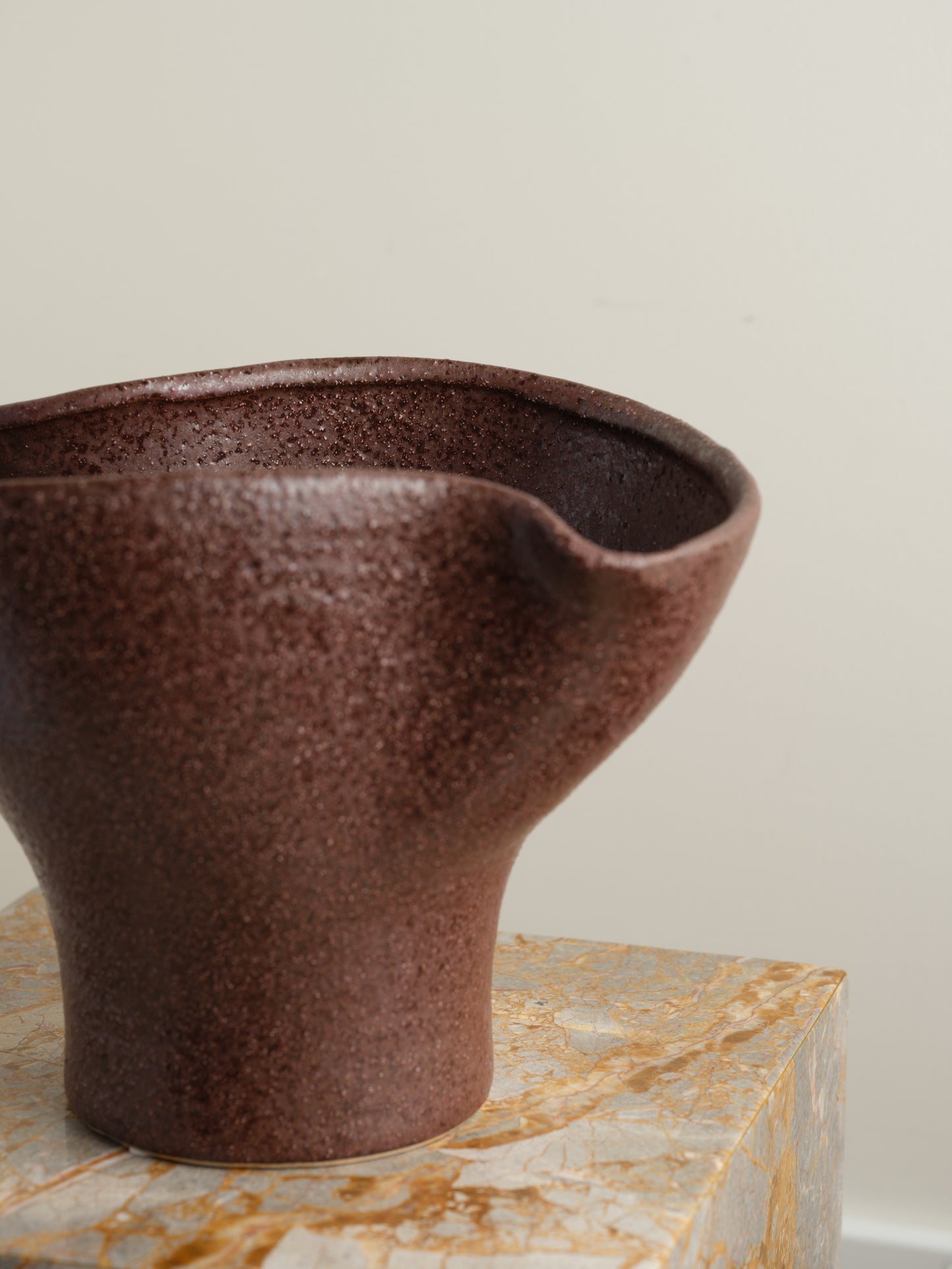 Hand-thrown brown stoneware vase with textured matte glaze and flared crest rim.