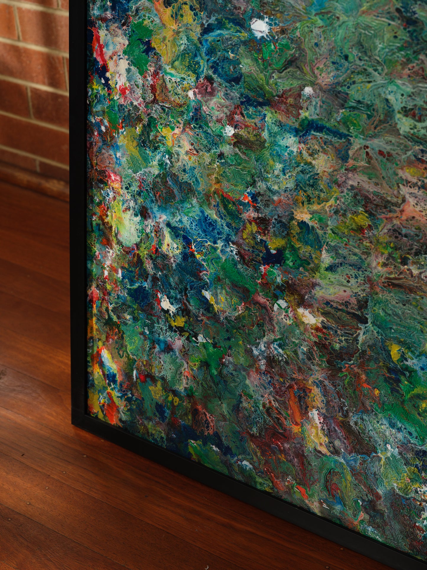 Abstract acrylic painting titled Verdant Drift I, featuring layered green, earthy, and colorful tones evoking organic movement.