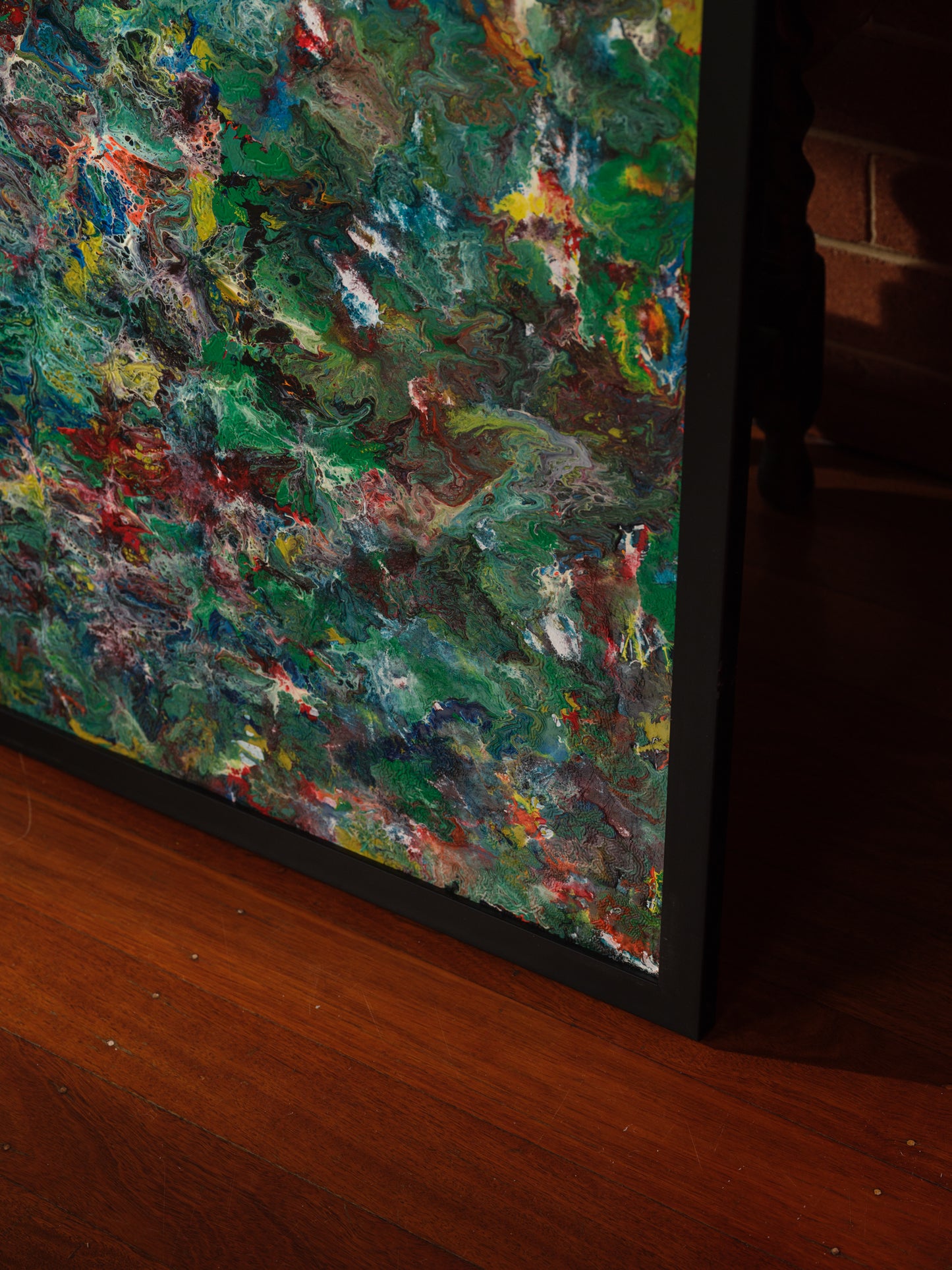 Abstract acrylic painting titled Verdant Drift I, featuring layered green, earthy, and colorful tones evoking organic movement.