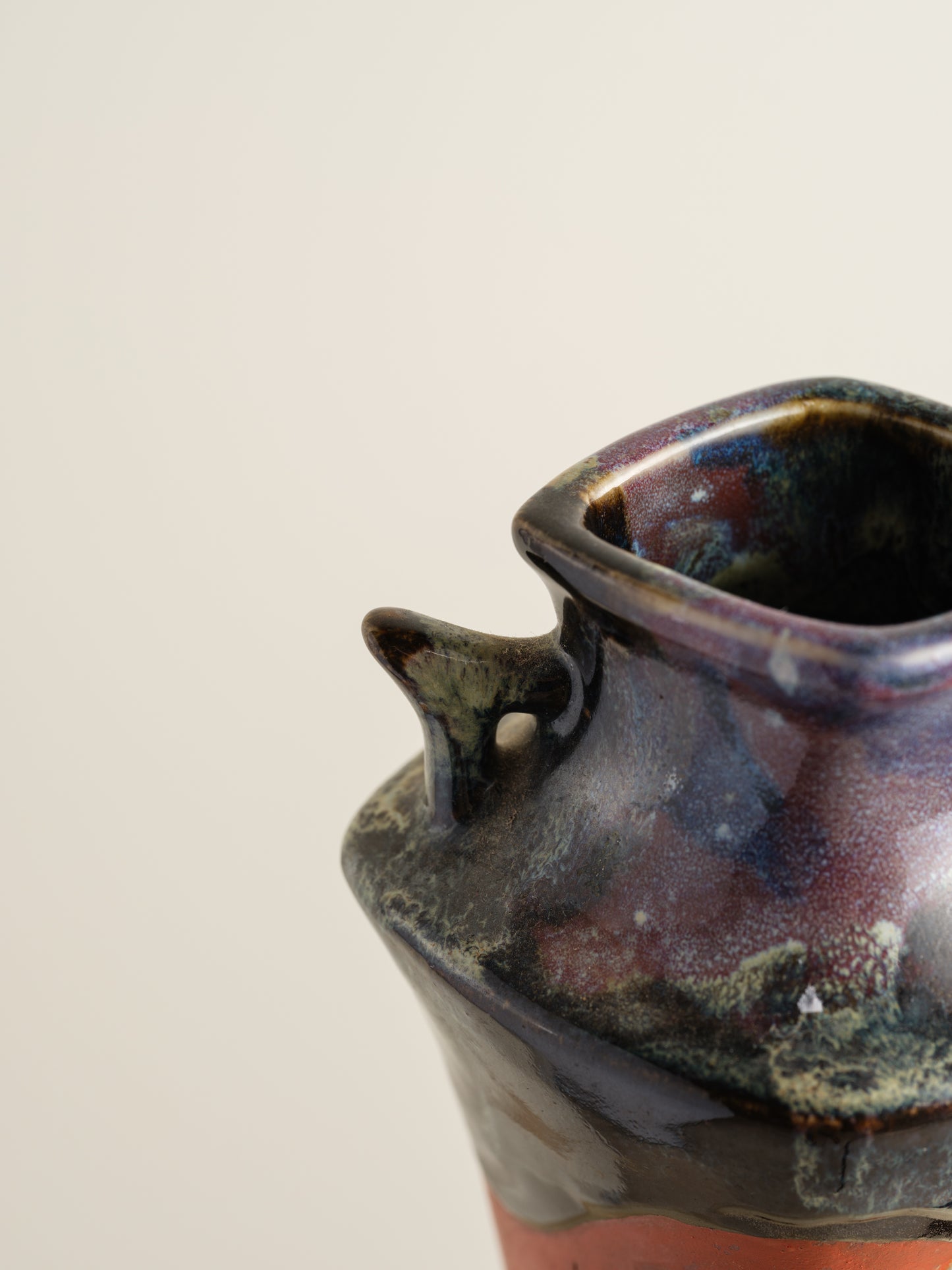 Vermilion Storyteller Relief Vase featuring hand-applied figurative relief on a tall form with dark glaze accents.