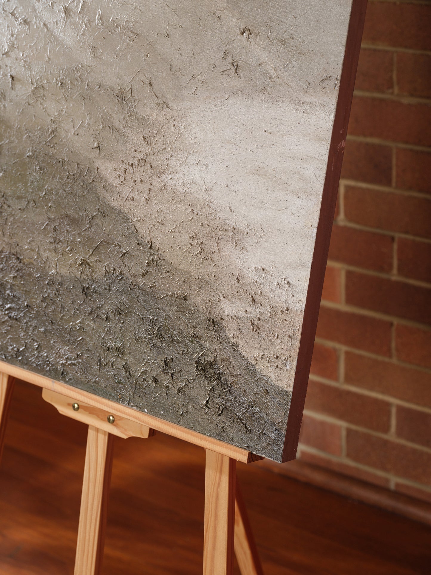 Abstract painting titled Whisper of the Inlet, featuring textured neutral tones of beige, grey, and white depicting a serene coastal landscape.