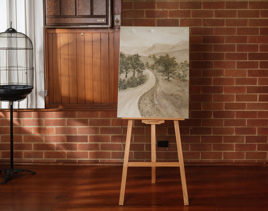 Abstract landscape painting titled Whispering Road, featuring a winding pale road through trees and hills in soft earthy tones