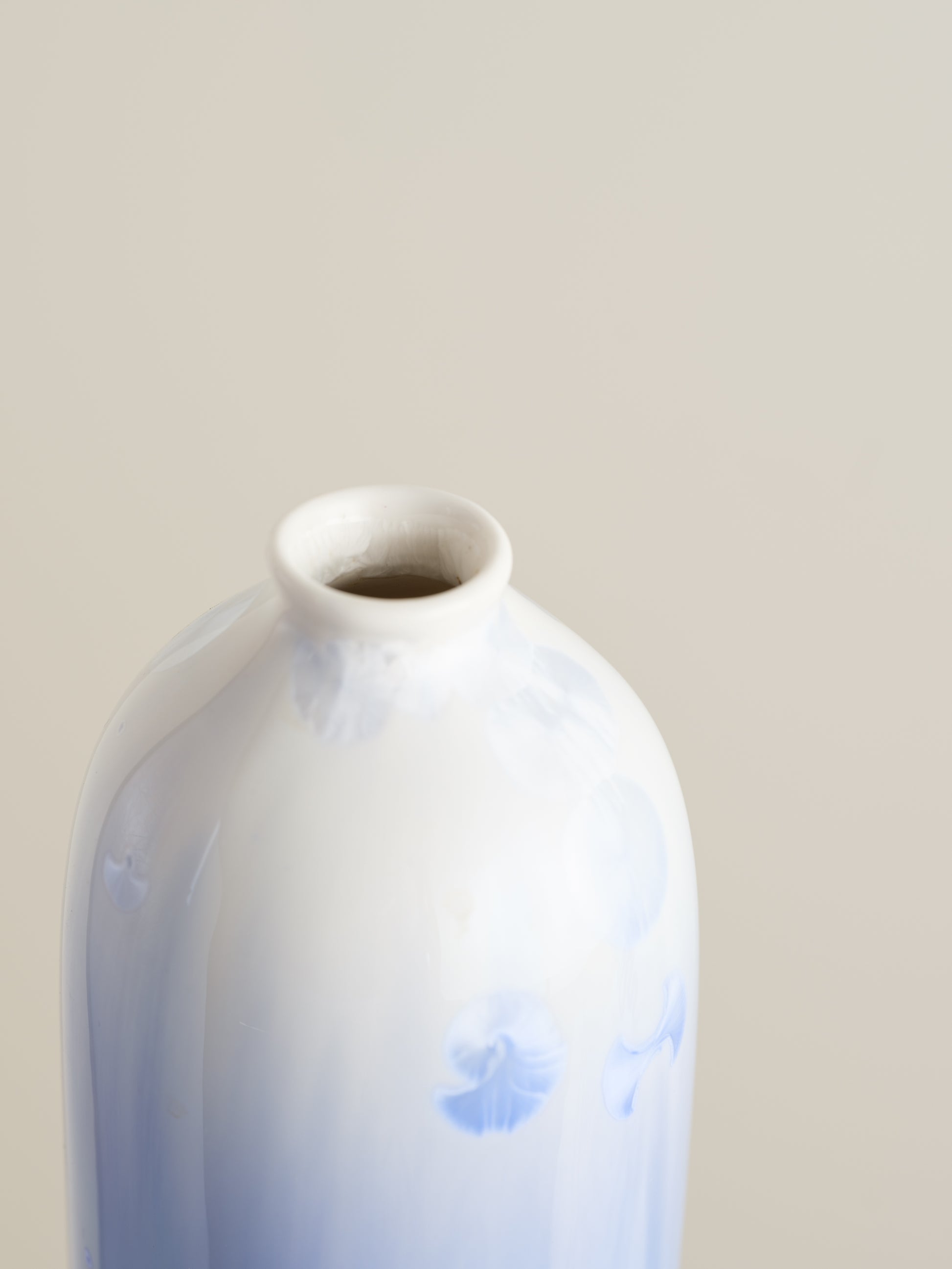 Tall crystalline glaze vase in gradient indigo blue with circular crystal bloom resembling a moon motif.