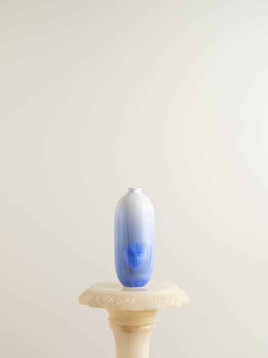 Tall crystalline glaze vase in gradient indigo blue with circular crystal bloom resembling a moon motif.