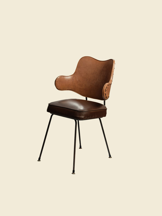 Mid-Century brown leather dining chair with padded seat and sculpted backrest on slim metal legs