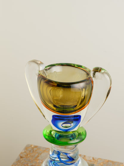 Multicoloured art glass vase with sculptural cup shape in yellow, green, blue and clear tones.
