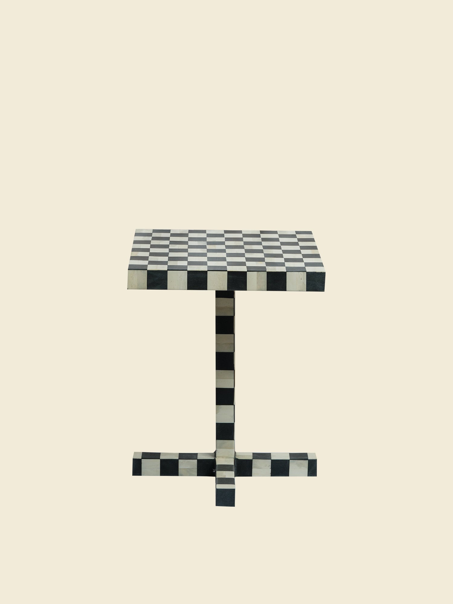 Modern black and white checkerboard side table with square top and pedestal base