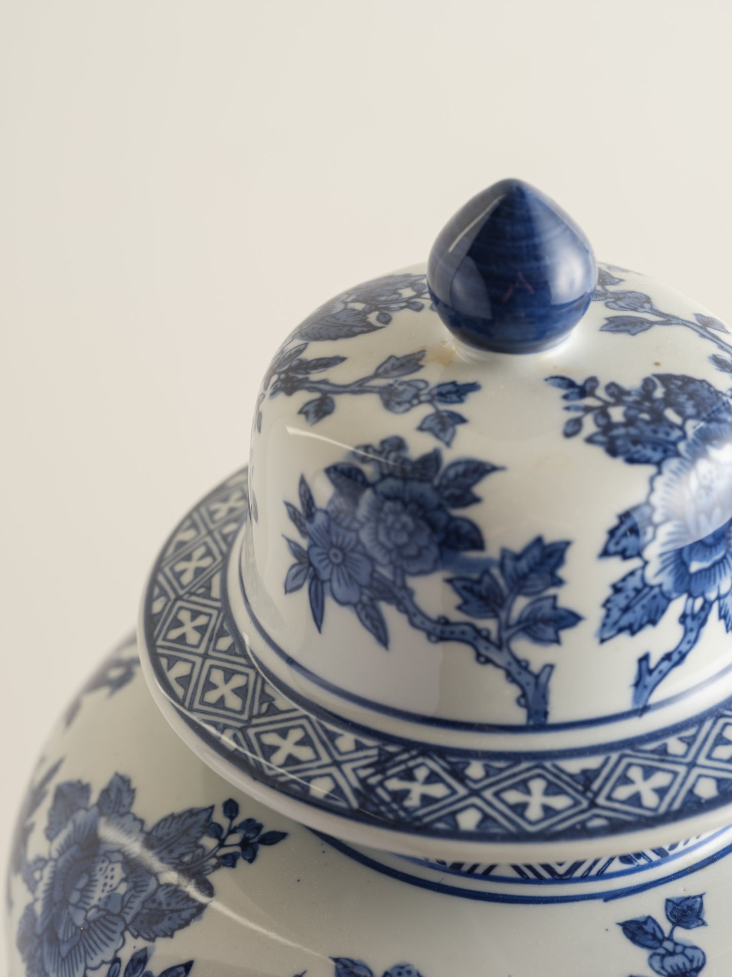 Blue and white porcelain ginger jar with phoenix and floral motif.