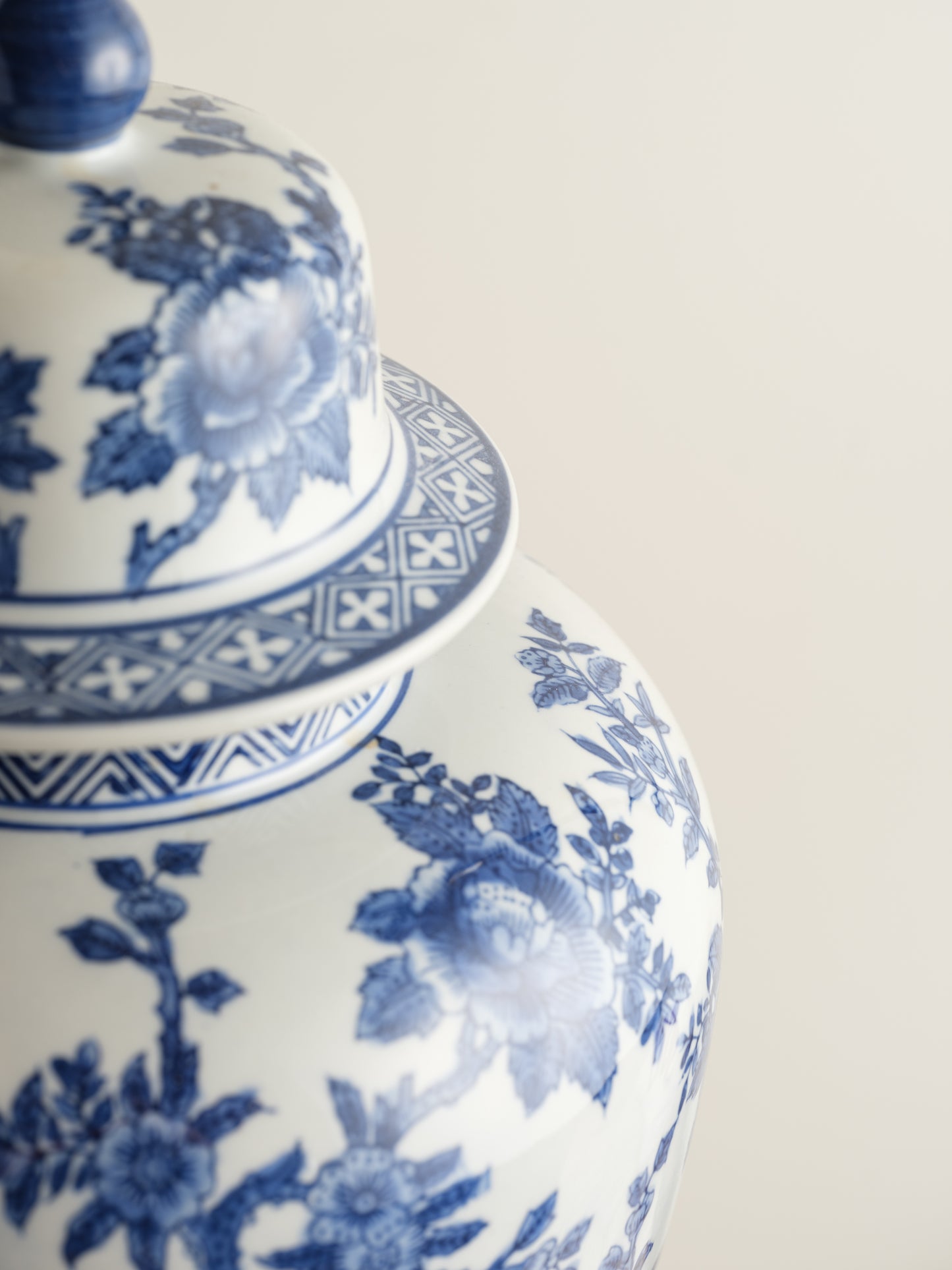 Blue and white porcelain ginger jar with phoenix and floral motif.