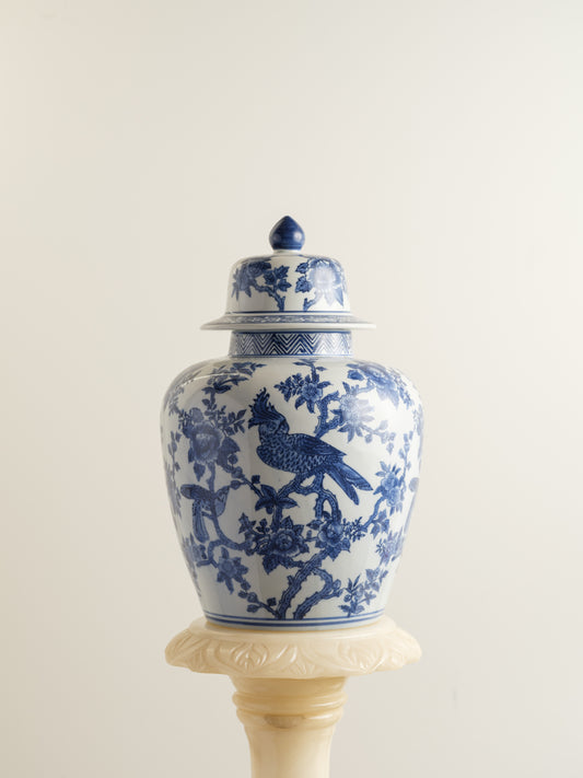 Blue and white porcelain ginger jar with phoenix and floral motif.